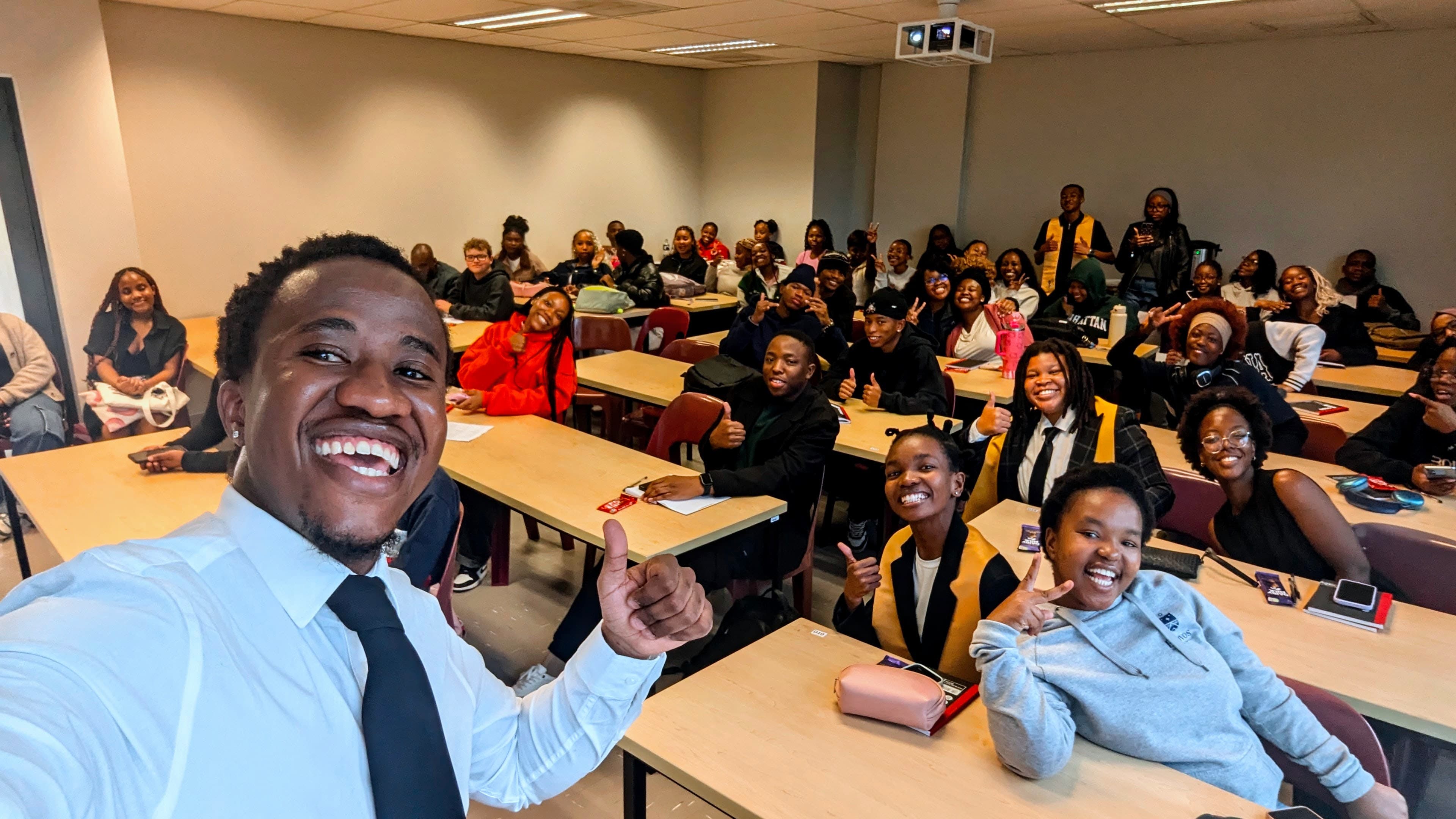 TK with a full lecture hall of students after a talk